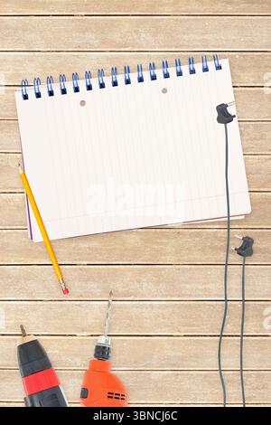 Tools and notepad on wooden background Stock Photo