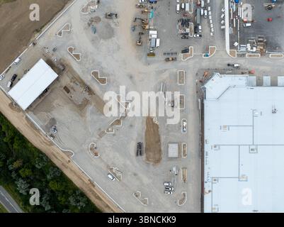 A top down aerial view above a construction site,  commercial real estate development, warehouse and gas station being built. Stock Photo