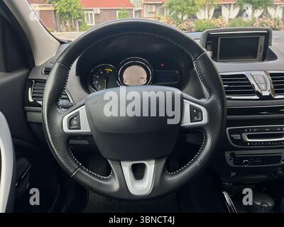 Explore the modern design of a stateoftheart car interior, featuring a stylish steering wheel and advanced dashboard displays that highlight innovativ Stock Photo