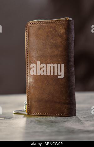 This elegant brown leather wallet features a zip closure, combining style and practicality for efficiently organizing cash and cards, making it a time Stock Photo