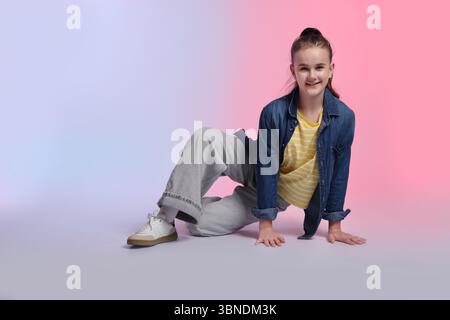 Girl in stylish clothes dancing on color background Stock Photo