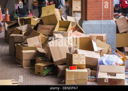 Taipei, Taiwan - 15 January, 2025 - Used cardboard boxes piled on street corners of Chinese New Year market on Dihua street Stock Photo