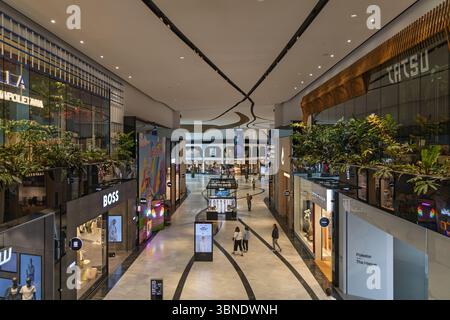 An interior view of the Westfield Mall of the Netherlands, featuring high-end stores, modern design, and shoppers enjoying the atmosphere. Leidschenda Stock Photo