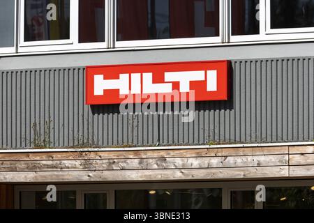 The bold red and white Hilti logo is displayed on a modern building facade, representing construction tools, technology, and industrial solutions. Utr Stock Photo