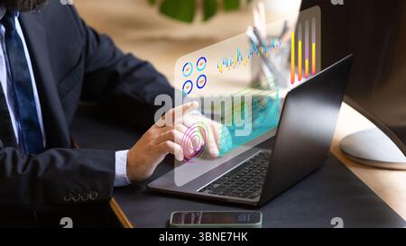 Businessman using futuristic transparent touchscreen interface to analyze real time financial data Stock Photo