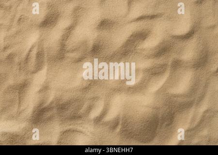 Sand texture. Beach abstract background. Backdrop for mockups. Summer vacation. Top view. Copy space. Stock Photo