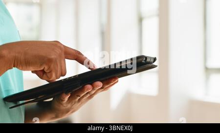 Close-Up of a Person Using a Tablet Device in a Modern Bright Environment Stock Photo