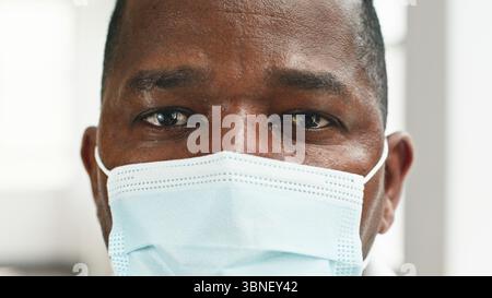 Focused Professional Wearing a Face Mask Shot in Close-Up for Public Health Emphasis Stock Photo