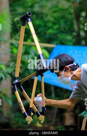 The process of painting a bicycle frame with bamboo material Stock Photo