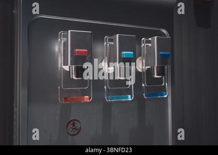 Close-Up of Water Dispenser with Hot, Cold, and Normal Temperature Taps Stock Photo