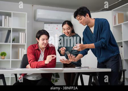 Teamwork and Creative Process. Engaging in UXUI design discussions at a collaborative workspace. Stock Photo