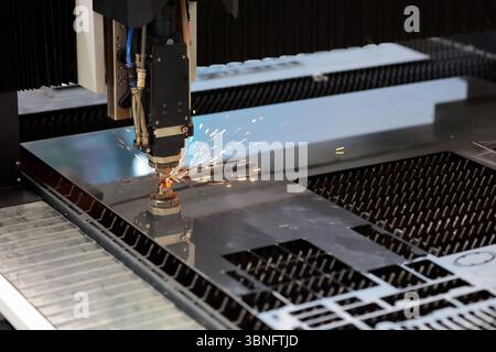 Sheet metal cutting process by CNC laser cutting machine. Selective focus. Stock Photo