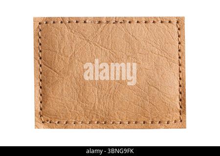 Brown leather patch with stitches. Label on fabric background. Clothing detail element. Closeup of blank rectangular tag. Textured surface for brandin Stock Photo