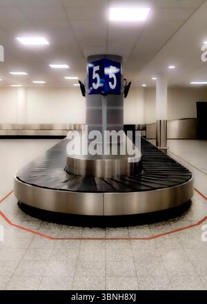An empty baggage carousel in an airport terminal. Stock Photo
