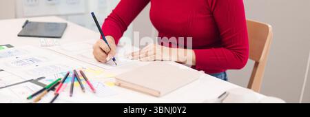 Adult Asian women in UI UX role designing website or application layout and user interface on paper for startup project. Focus on hands creating proto Stock Photo