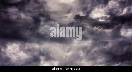 Storm clouds are forming turbulent swirls across flat design overcast sky with charcoal patterns Stock Photo