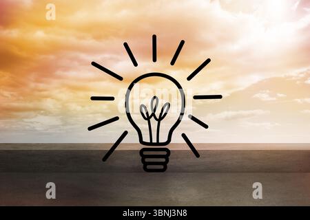 Displaying glowing lightbulb icon on concrete deck facing sea horizon with warm sky in flat design Stock Photo