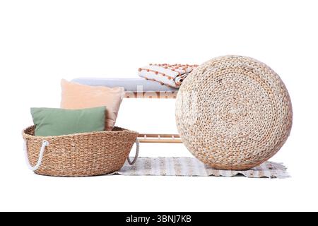 Stylish grey bench with wicker pouf, basket and cushions isolated on white background Stock Photo