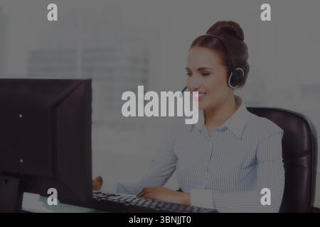 Caucasian smiling businesswoman wearing headset using computer on desk in office, copy space Stock Photo