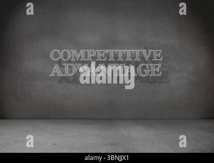 Minimalist gallery is displaying chalk style white COMPETITIVE ADVANTAGE text on grey concrete wall Stock Photo