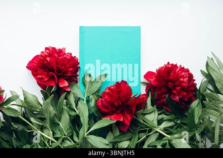 A stunning bouquet of vibrant red peonies placed stylishly in a cozy home setting, offering a touch of natural elegance and vibrant color to the room Stock Photo