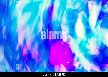 A dynamic abstract image showcasing swirling blue, purple, and white hues, capturing the essence of chromadynamics. The vibrant waves create a mesmeri Stock Photo