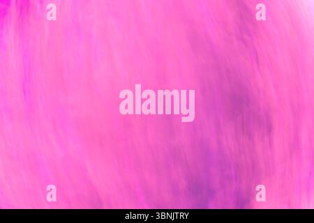 A captivating abstract image featuring fluid waves of vibrant pink hues. The dynamic interplay of color tones creates a soothing yet energetic visual Stock Photo