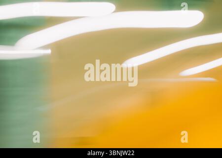 A bright, abstract light background featuring blurred hues of yellow and green with fluid white streaks. Ideal for digital designs, presentations, and Stock Photo