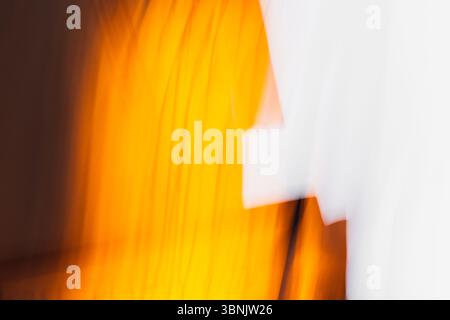Abstract light background featuring a captivating blend of warm orange and cool white tones. The gradient effect creates a sense of fluidity and dynam Stock Photo
