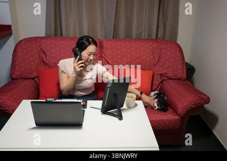 Asian woman professional working from home using laptop computer ...