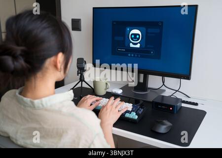 A young professional utilizes a robot assistant in a minimalist home workspace, enhancing productivity and innovation through AI technology and a mech Stock Photo