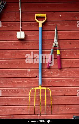 Garden tools hanging on a wall Stock Photo