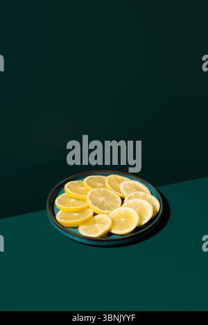 A striking image featuring vibrant lemon slices on a dark background, highlighting the fresh and vivid yellow tones. A perfect representation of healt Stock Photo