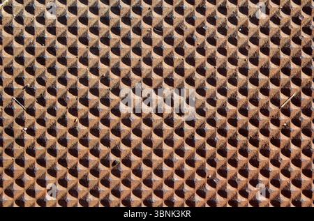 Raised diamond-shaped facets repeating pattern brown abstract textured background Stock Photo