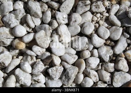Close up textured abstract background of white stone pebbles Stock Photo