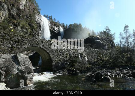 Norway - 19th April 2025 - Image of Hesjedalsfossen waterfall with sun rays shining through water spray on a sunny afternoon Stock Photo
