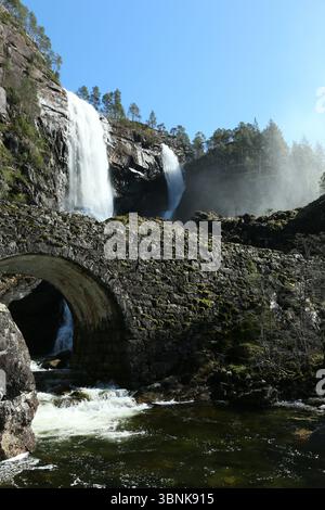 Norway - 19th April 2025 - Image of Hesjedalsfossen waterfall with sun rays shining through water spray on a sunny afternoon Stock Photo