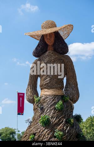 East Molesey, Surrey, UK. 30th June, 2025. A wicker Jane Austen figure at the RHS Hampton Court Palace Garden Festival 2025 made by Environmental Artists Rebecca & Mark Ford celebrating 60 years of fashion in Kingston. Contemporary artists Mark Antony Haden Ford and Rebecca Ford of Two Circles Design work with natural materials.  Working at their studio in Slindon, within the South Downs National Park, making for both public and private sectors. Both have a strong interest in the archaeology, geography and wonders of the natural world, drawing on traditions and techniques of willow craft and w Stock Photo