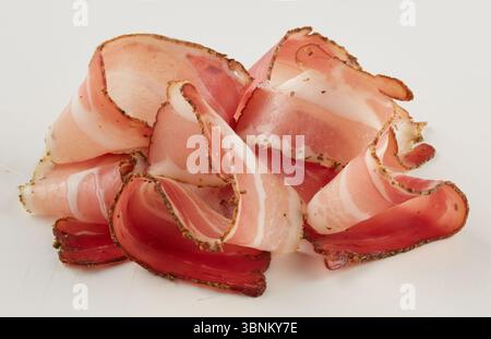 Several thin slices of smoked pork Stock Photo