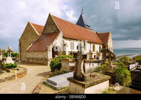 Cimitiere Marin artists' cemetery with Eglise Saint Valery in Varengeville-sur-Mer in front of a dramatic stormy sky with a view of the Alabaster Coast (Cote d'Albätre) in the Seine-Maritime department in the Normandy region of France Stock Photo