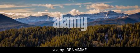 Snow-capped Rocky Mountains under a vibrant blue sky Stock Photo