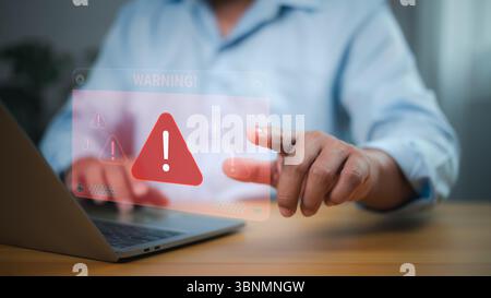 Cybersecurity threats, data breaches, system vulnerabilities, and digital risk management. Person interacting with holographic WARNING! sign and red t Stock Photo