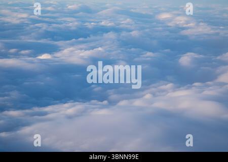 cloudscape, looking down at the white puffy clouds in a blue sky Stock Photo