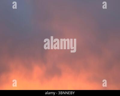 Witness a stunning display of colors in the beautiful sunset sky, creating a serene and peaceful atmosphere. Stock Photo