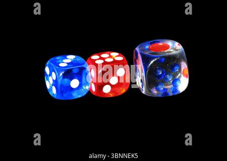 Three casino dice on a black background. Three traditional dice on the black background. Stock Photo