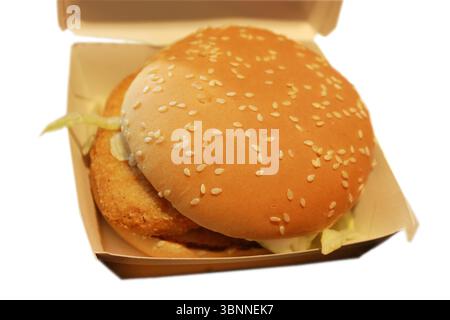 Delicious chicken burger, burger with crispy chicken meat, salad and sauce in the box on white background. Stock Photo