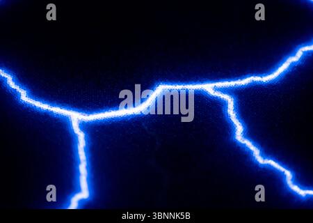 Vibrant electric blue lightning bolts illuminate a dark background, creating a striking contrast. The vivid energy and dynamic lines evoke a sense of Stock Photo