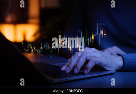 Stock market analysis and trading concept. Hands typing on laptop with candlestick chart, data points, and financial graph, represent stock market Stock Photo