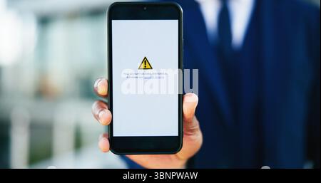 Business person, hands and phone screen with warning message for restricted access or notification. Closeup, accountant or user with mobile smartphone Stock Photo