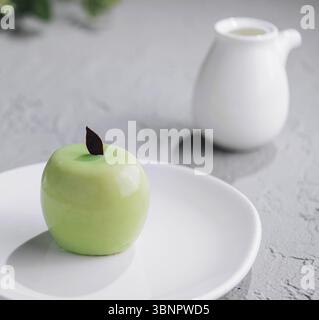 Apple shaped mousse cake and tea Stock Photo